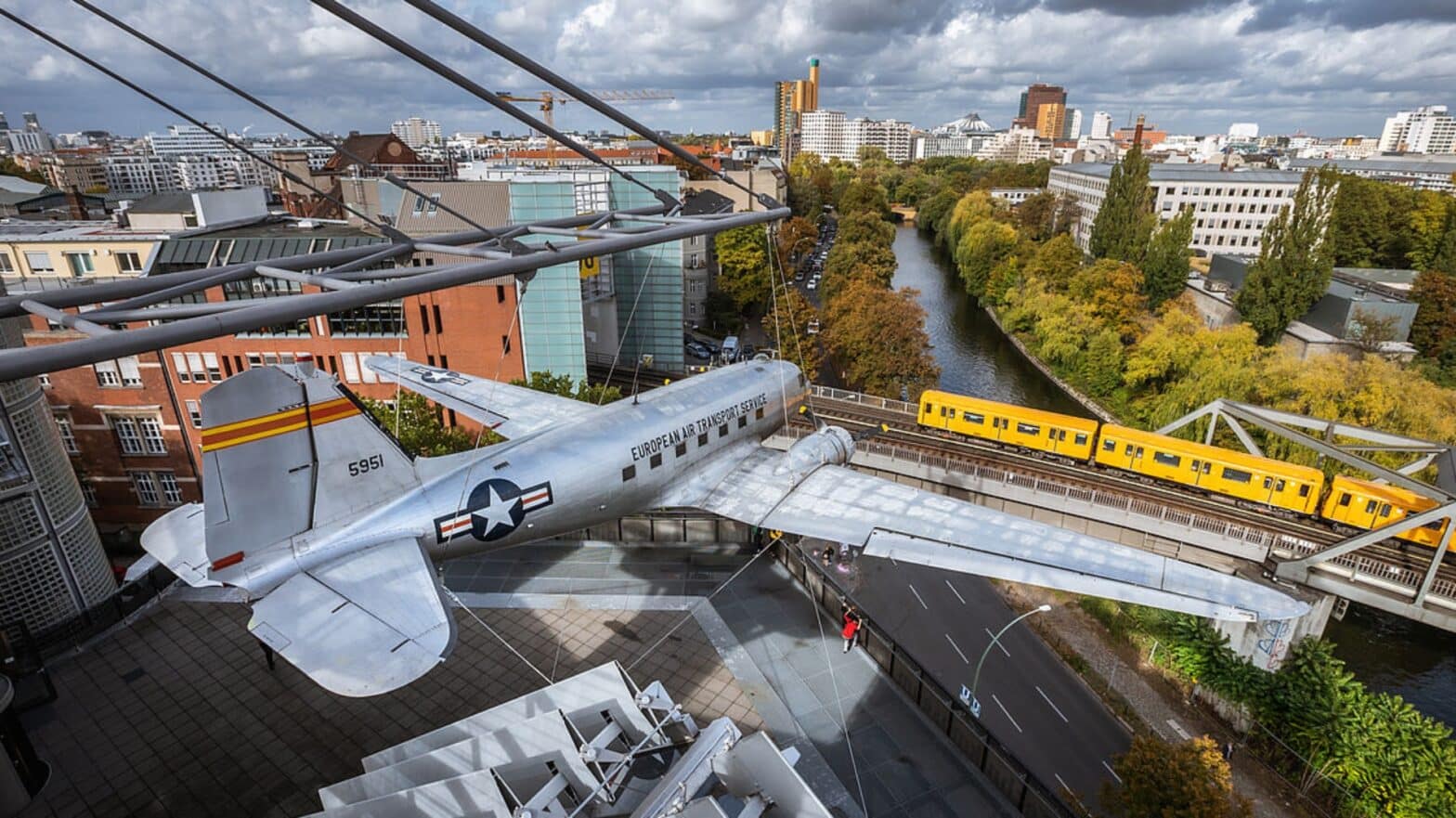 View from above of the German Museum of Technology in Berlin. In front an airplane, in the background a suburban train.